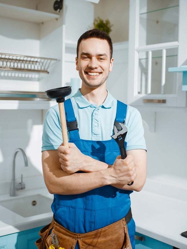 cheerful male plumber holds wrench and plunger resize
