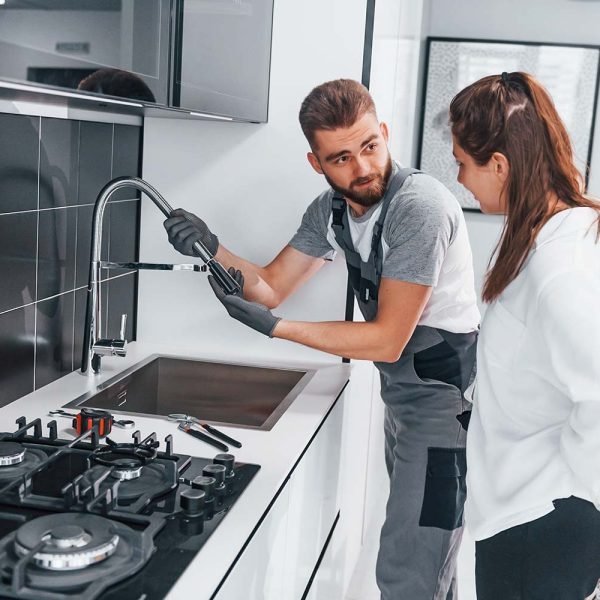 young professional plumber in grey uniform shows r resize